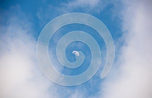 Half moon with clouds and blue sky