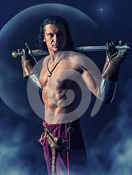 Half naked warrior with a sword in the mystic background
