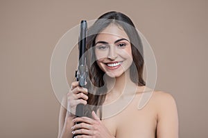 Half-naked woman with curling iron near head