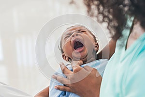 half Nigeria half Thai, 1-month-old baby newborn son, crying while his mother being held