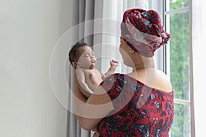 Half-Nigerian, half-Thai, 2 months old, sleeping on mother's palm.