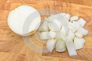 Half of onion and chopped onion on chopping block