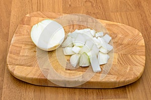 Half of onion and chopped onion on chopping block