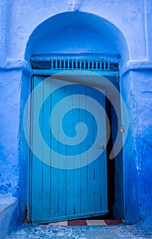 Half-open blue door in Chefchaouen, Medina, Morocco