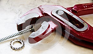 Half-opened deep red pliers with screw and washer  3