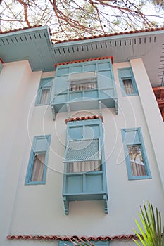 Half opened windows on the facade of traditional turkish house