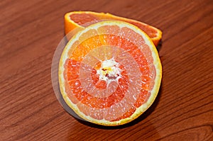 Half orange jucy fruit, close up, wood background