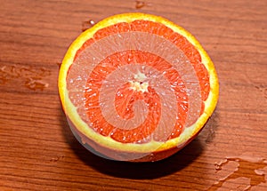 Half orange jucy fruit, close up, wood background