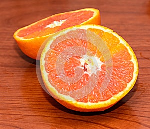 Half orange jucy fruit, close up, wood background