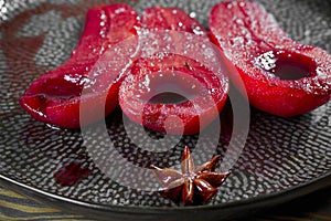 Half a pear in wine with anise and cinnamon