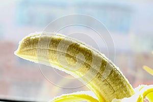 Half peeled banana close up