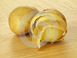 Half peeled potatoes