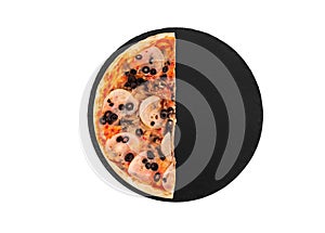 Half of pizza with ham, mozzarella, mushrooms and olives on a black slate platter, isolated on white, top view