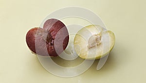 Half of Plumcot and Yellow Plum fruit