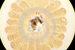 Half of pomelo, chinese grapefruit on black