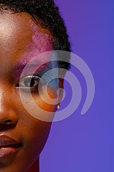 Half portrait of african american woman with short hair and colourful makeup