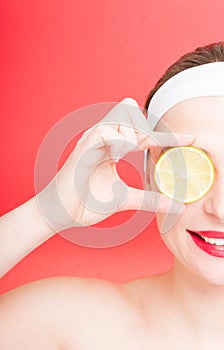 Half portrait of beautiful woman with lemon