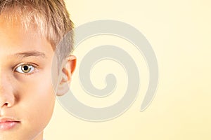 Half portrait of cute teenager boy on yellow background