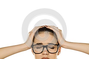 Half portrait of young stressed woman with headache