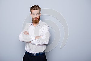 Half-profile portrait of serious confident bearded man keeping