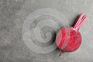 Half of raw beet on grey table, top view. Space for text