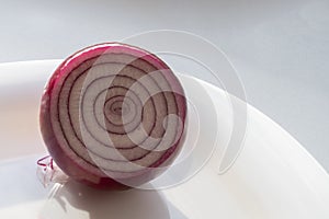 Half of red onion on white plate