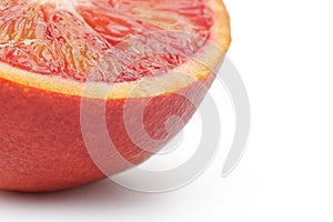 Half of ripe blood red orange white background