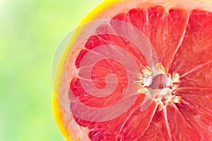 Half of Ripe Juicy Red Grapefruit on Greenery Nature Background. Vitamins Healthy Diet Summer Detox Vegan Superfoods Concept