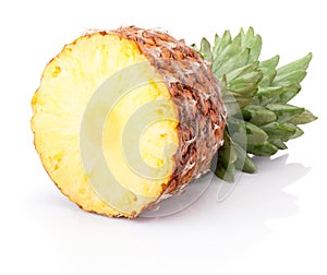 Half ripe pineapple lying horizontally isolated on white background