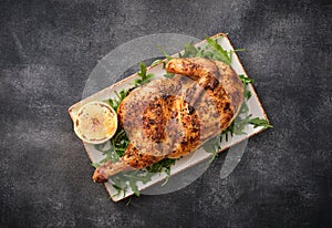 Half roasted chicken Piri Piri served with lemon . Grilled poultry