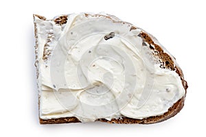 Half slice of rye bread with cream cheese spread isolated on white from above. photo