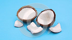 Half and sliced coconut appear on blue theme. Stop motion