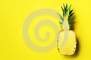 Half of sliced pineapple on yellow background. Top View. Copy Space. Bright pattern for minimal style. Pop art design