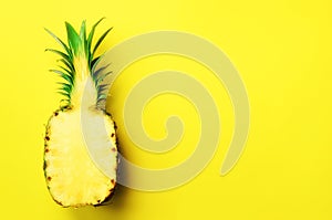 Half of sliced pineapple on yellow background. Top View. Copy Space. Bright pattern for minimal style. Pop art design