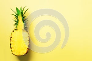 Half of sliced pineapple on yellow background. Top View. Copy Space. Bright pattern for minimal style. Pop art design