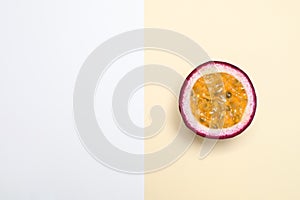 Half of tasty fresh passion fruit maracuya on color background. Space for text