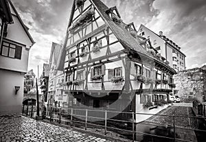 Half-timbered Crooked House or Hotel Schiefes Haus in black and white, Ulm, Germany. It is tourist attraction of Ulm