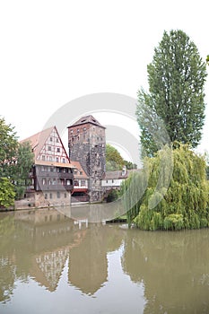 Half-timbered house and medieval tower in the Old Town of Nuremberg, Germany