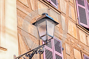 Half timbered house and street lantern. Details. Colmar town, France