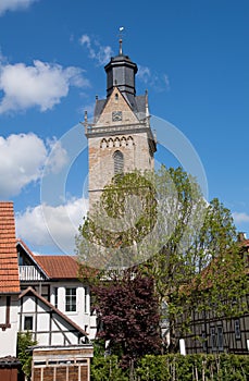 Half timbered house with the tower of the Saint Kilian church in Korbach