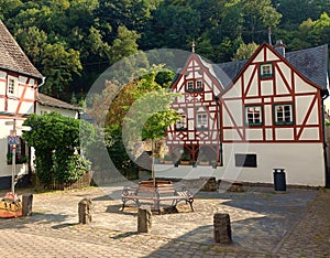 Half timbered houses and a bench in village Monreal in german region Eifel