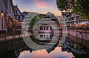 Half timbered houses by canals of Petite France in Strasbourg, France at sunset