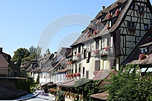 Half-timbered houses decorated with flowers along the riverbanks of the the romantic canal in Colmar. France