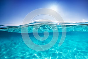 Half underwater shot, clear water and sunny blue sky. Tropical ocean