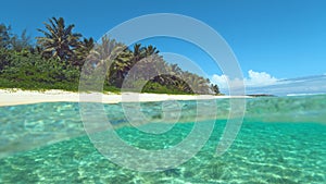 HALF UNDERWATER: Turquoise water washes the beautiful exotic white sand beach.