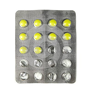 Half used pack of yellow pills isolated on white background.