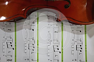 half violin with book music note background