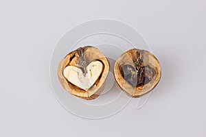 Half a walnut with a heart shape in the middle. The concept of love for nuts. Good and evil. Valentine's Day.