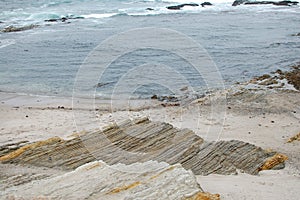 Half water, half rocks and sand