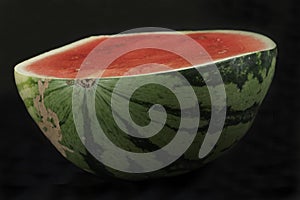 Half watermelon isolated on black background